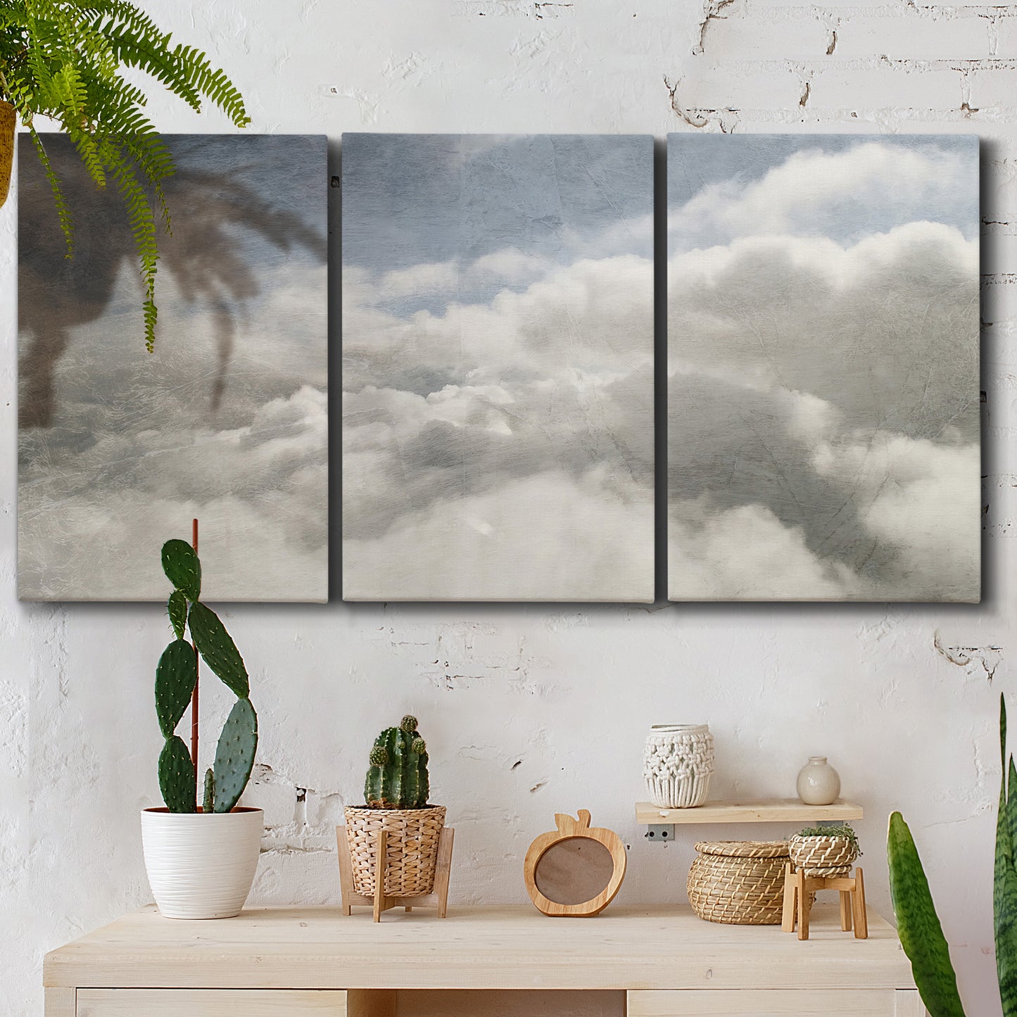 Three-panel canvas wall art featuring aerial landscape view photograph, displayed in a boho-chic entryway above a console table.