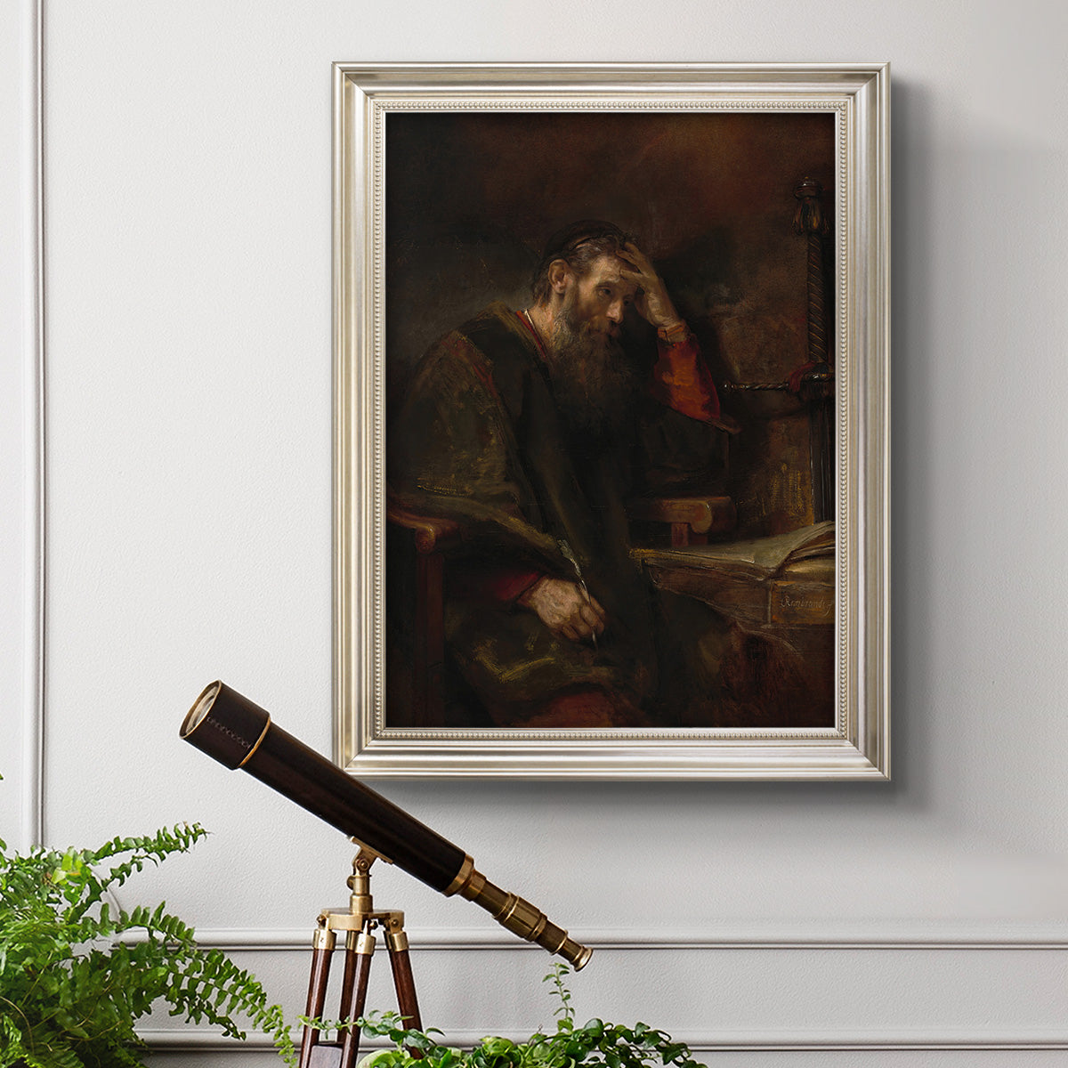 Classical religious portrait of Paul the Apostle by Rembrandt van Rijn in an ornate champagne frame displayed in a light-toned interior setting.