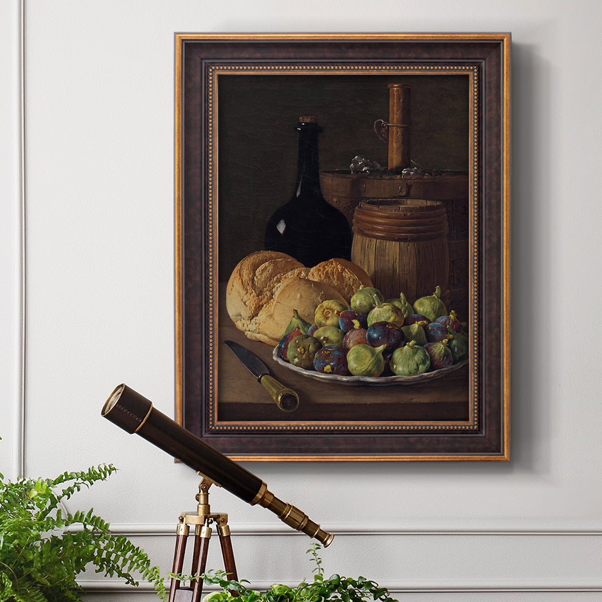 Realist still life with figs and bread by Luis Meléndez in an ornate bronzed mahogany wood frame displayed in a light-toned interior setting.