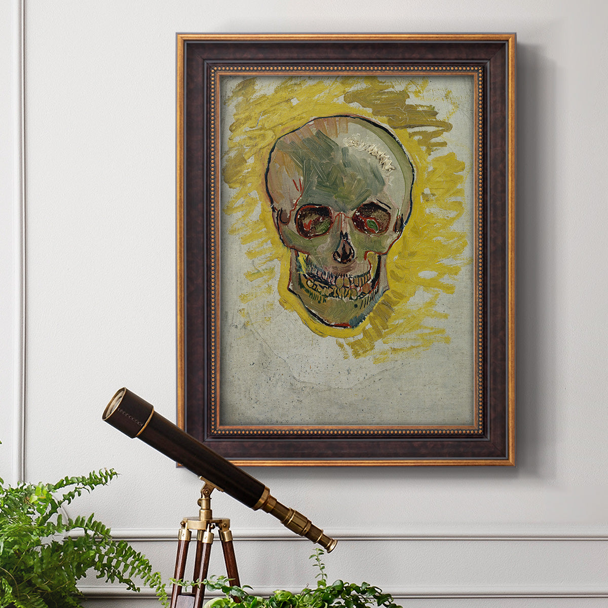 Expressive skull study painting by Vincent van Gogh in an ornate bronzed mahogany wood frame displayed in a light-toned interior setting.