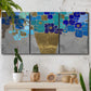 Three-panel canvas wall art featuring blue floral abstract botanical expression, displayed in a boho-chic entryway above a console table.