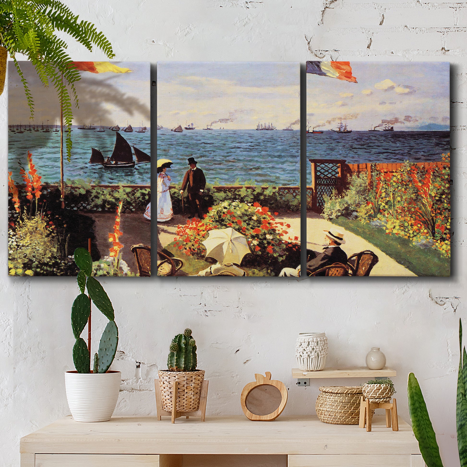Three-panel canvas wall art featuring coastal garden overlooking sea, displayed in a boho-chic entryway above a console table.