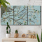 Three-panel canvas wall art featuring blue sky with flowering branches, displayed in a boho-chic entryway above a console table.