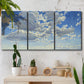 Three-panel canvas wall art featuring whimsical cloud filled sky landscape, displayed in a boho-chic entryway above a console table.