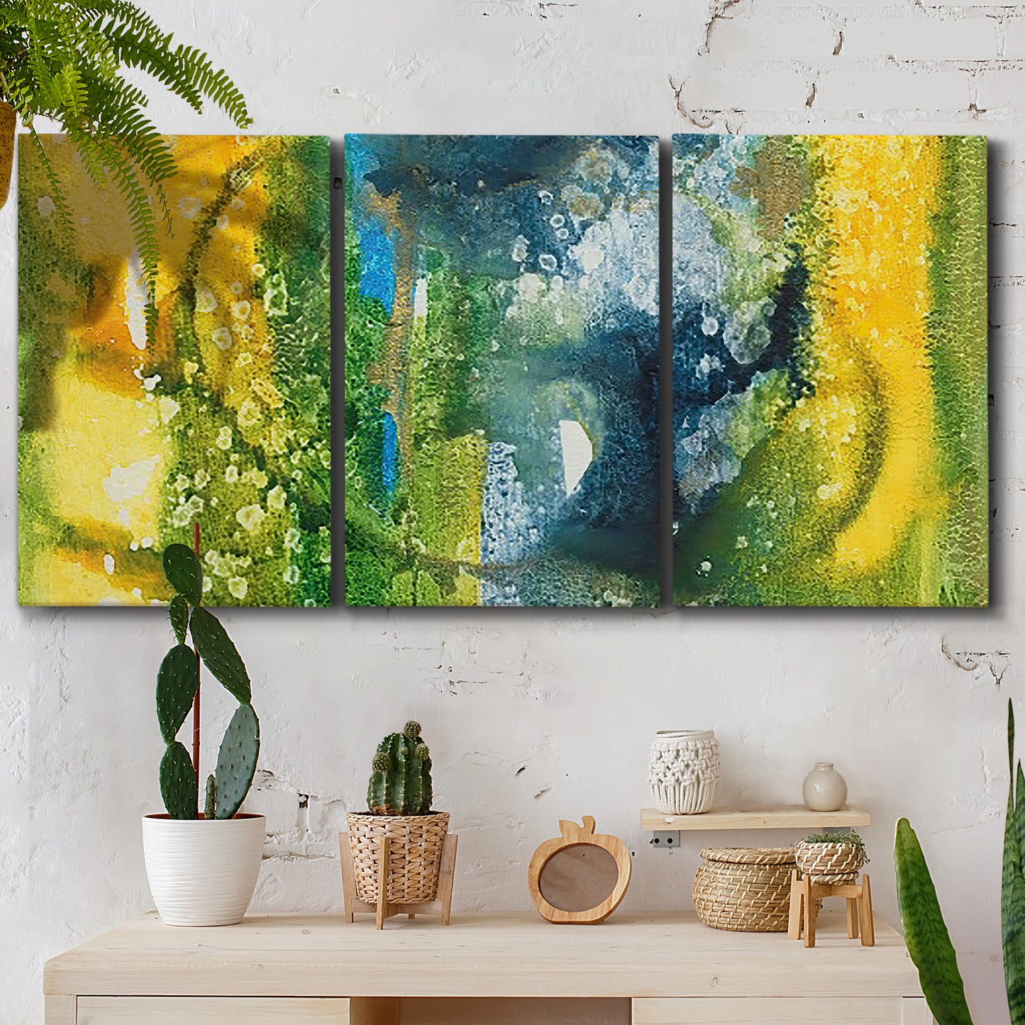 Three-panel canvas wall art featuring energetic abstract aquatic color motion, displayed in a boho-chic entryway above a console table.