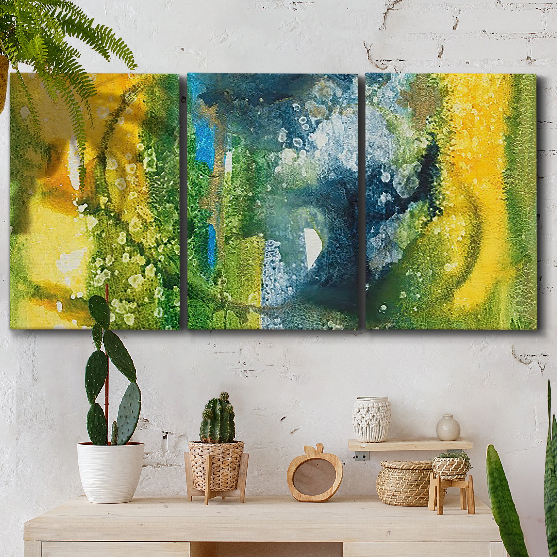 Three-panel canvas wall art featuring energetic abstract aquatic color motion, displayed in a boho-chic entryway above a console table.