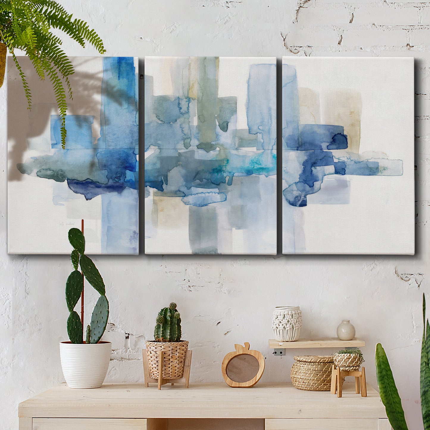 Three-panel canvas wall art featuring minimal urban skyline watercolor, displayed in a boho-chic entryway above a console table.