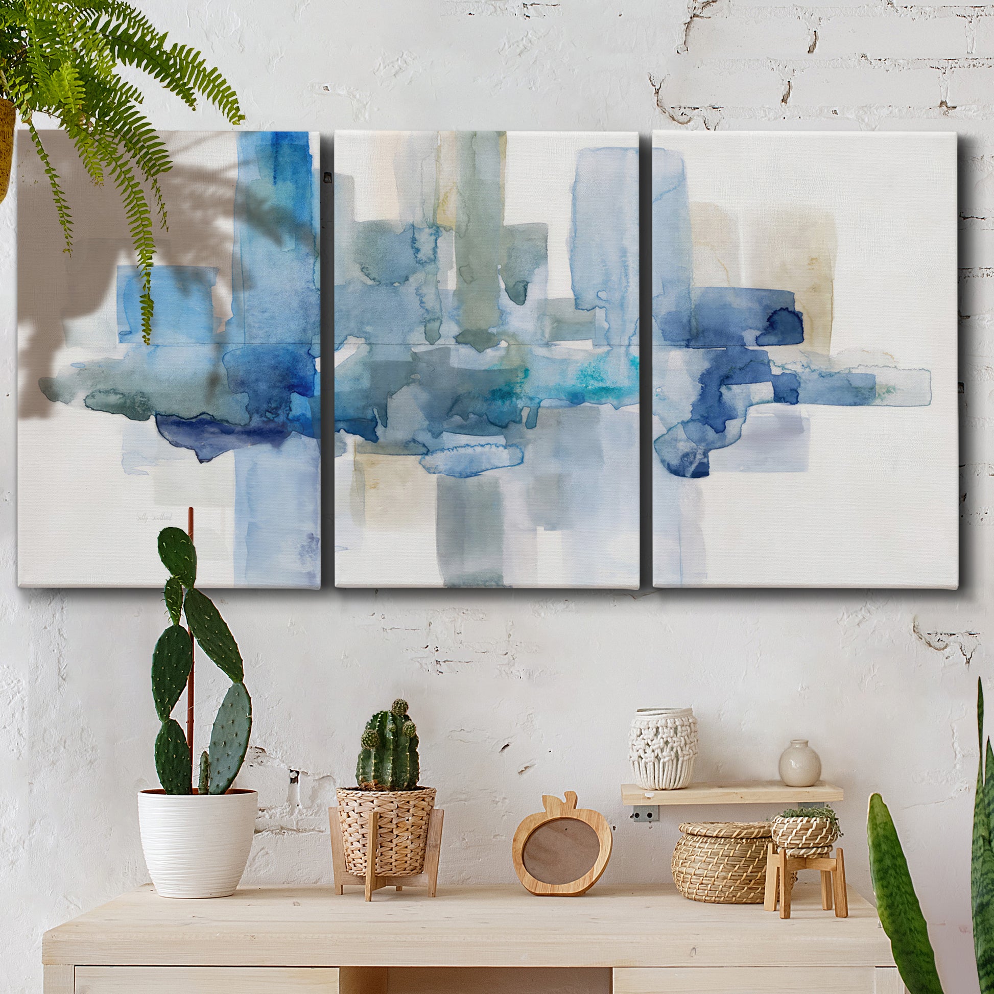 Three-panel canvas wall art featuring minimal urban skyline watercolor, displayed in a boho-chic entryway above a console table.