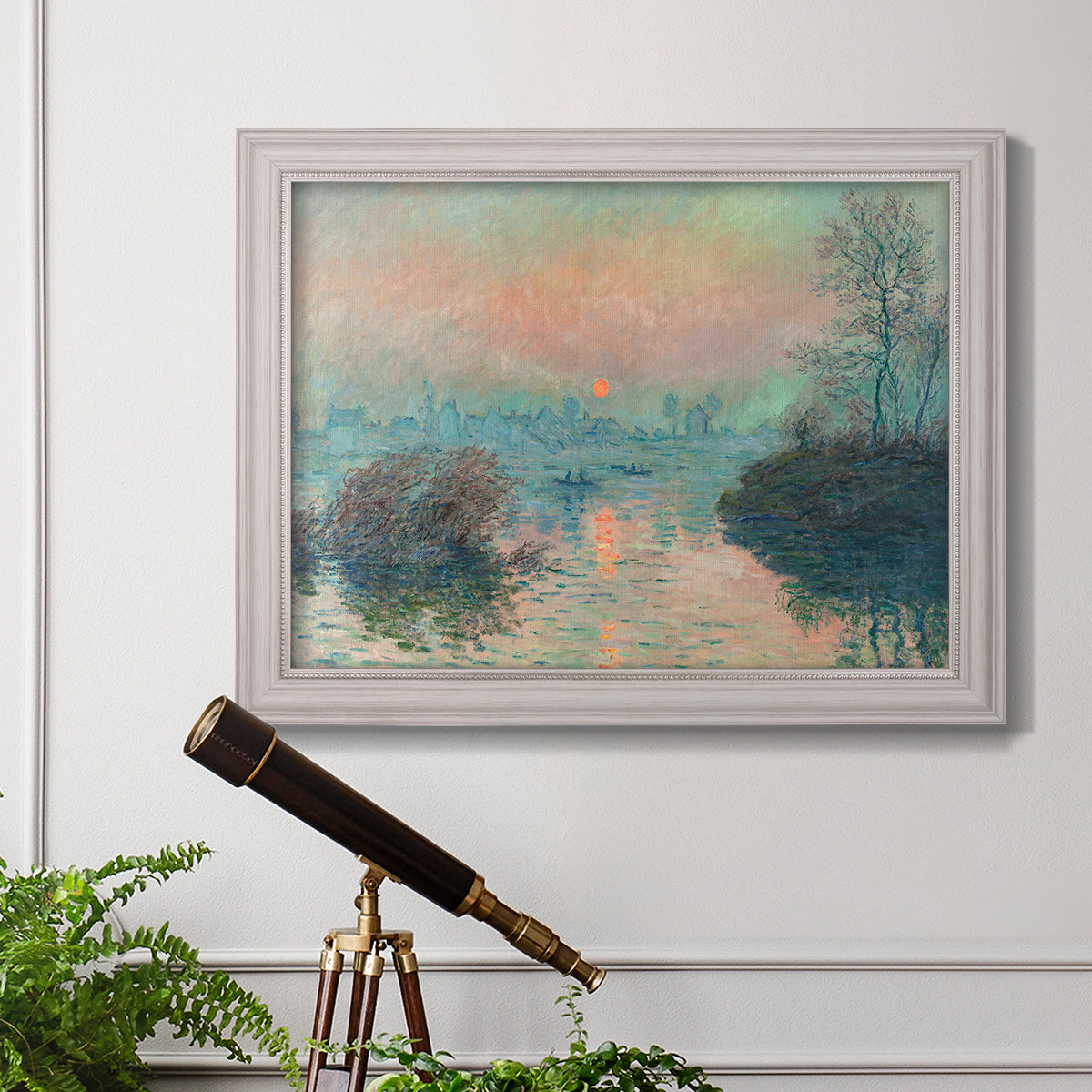 Impressionist winter river sunset scene by Claude Monet in an ornate weathered white frame displayed in a light-toned interior setting.