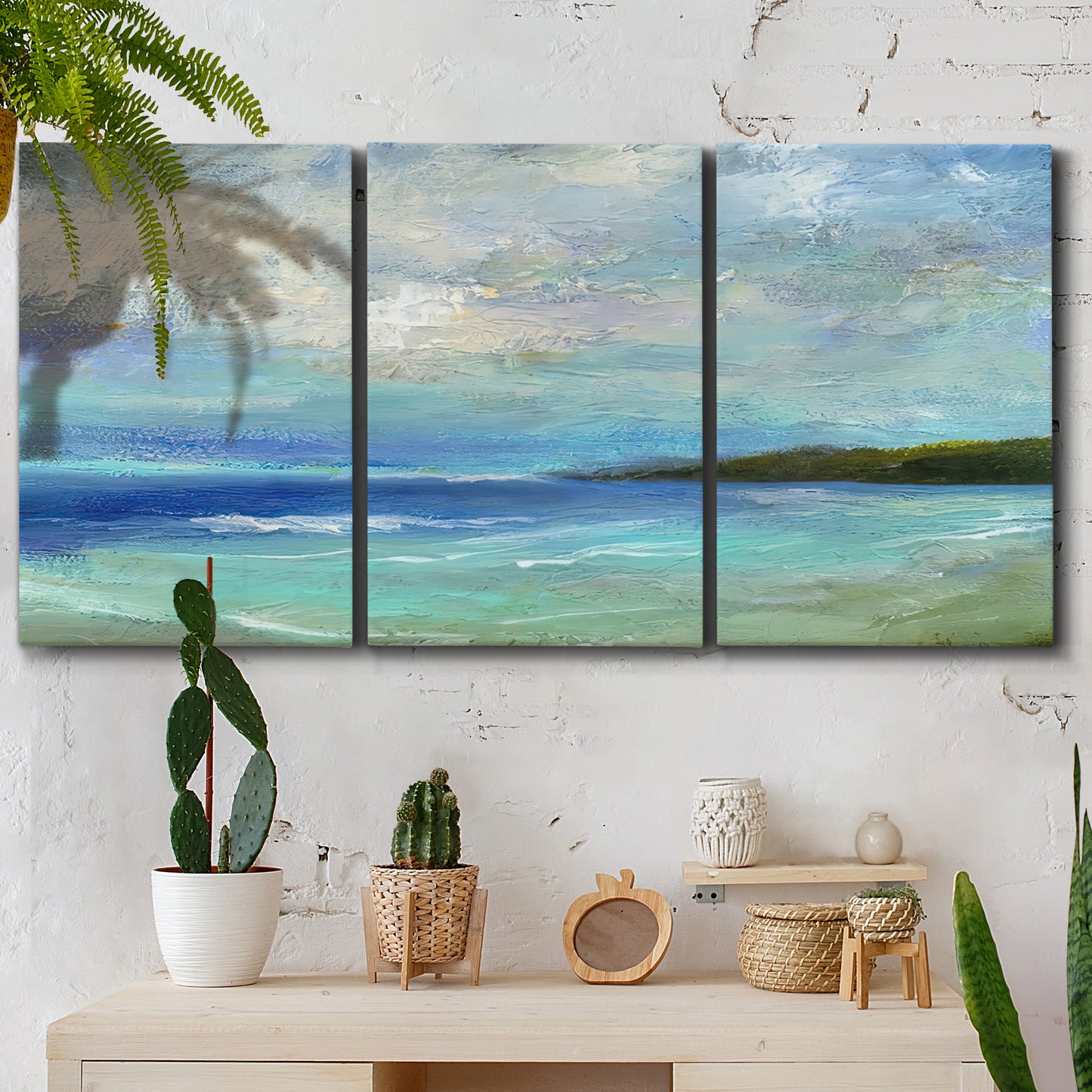 Three-panel canvas wall art featuring narrow island inlet waters, displayed in a boho-chic entryway above a console table.