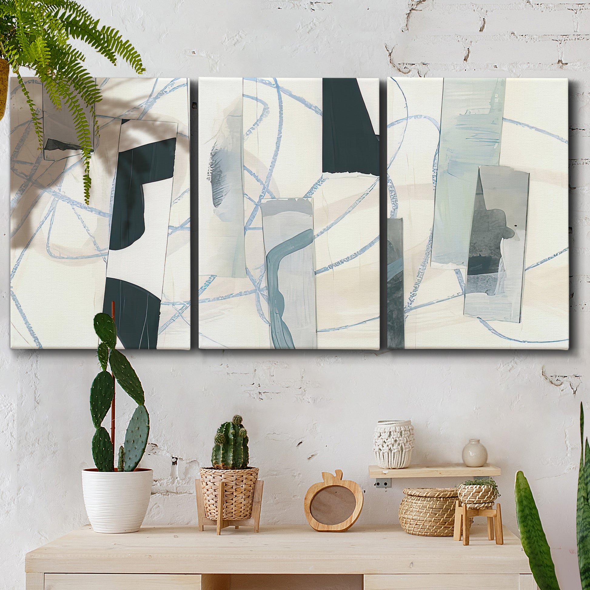Three-panel canvas wall art featuring interwoven icy abstract linear forms, displayed in a boho-chic entryway above a console table.