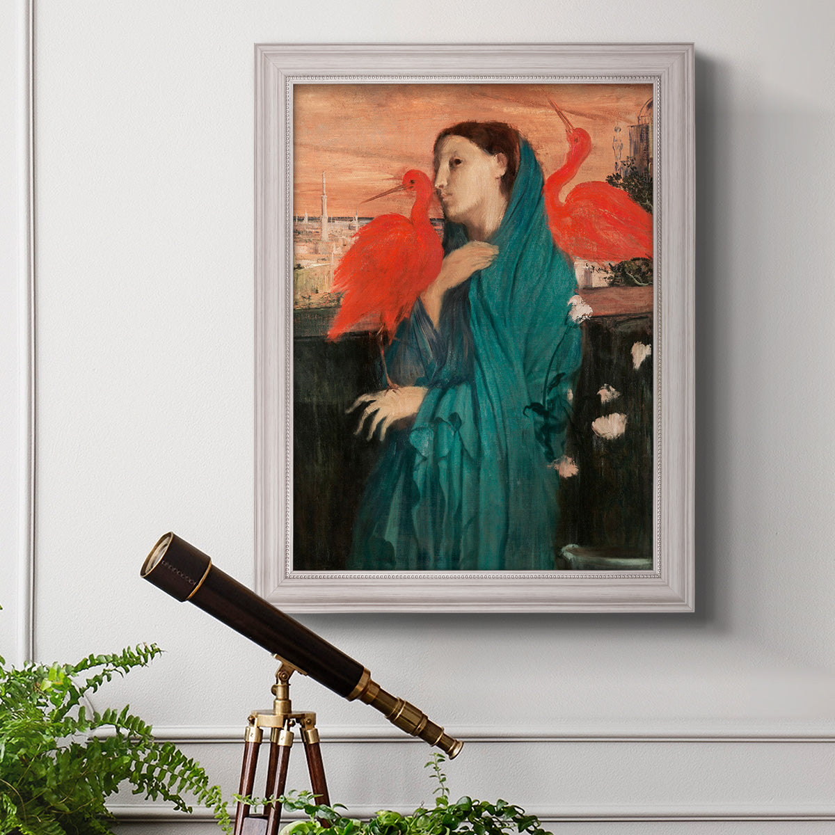Impressionist portrait of a young woman with an ibis by Edgar Degas in an ornate weathered white frame displayed in a light-toned interior setting.