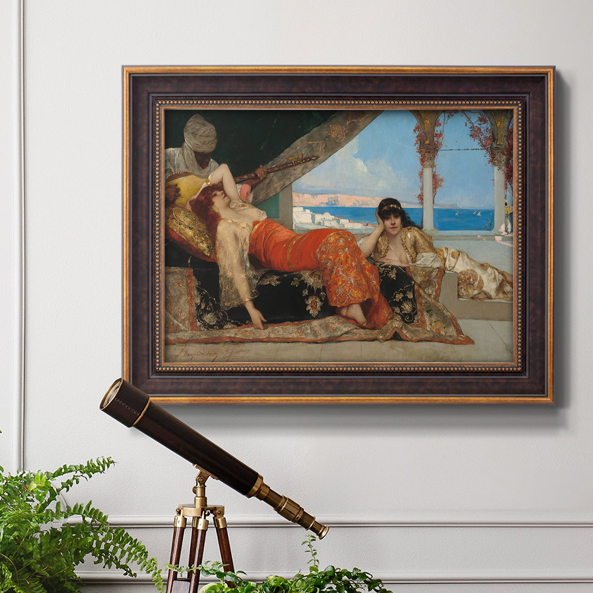 Orientalist portrait scene by Jean-Joseph Benjamin-Constant in an ornate bronzed mahogany wood frame displayed in a light-toned interior setting.