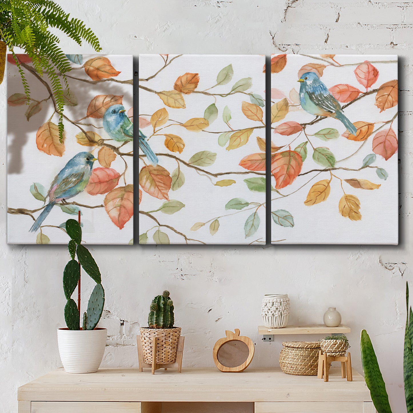Three-panel canvas wall art featuring decorative bird trio illustration, displayed in a boho-chic entryway above a console table.