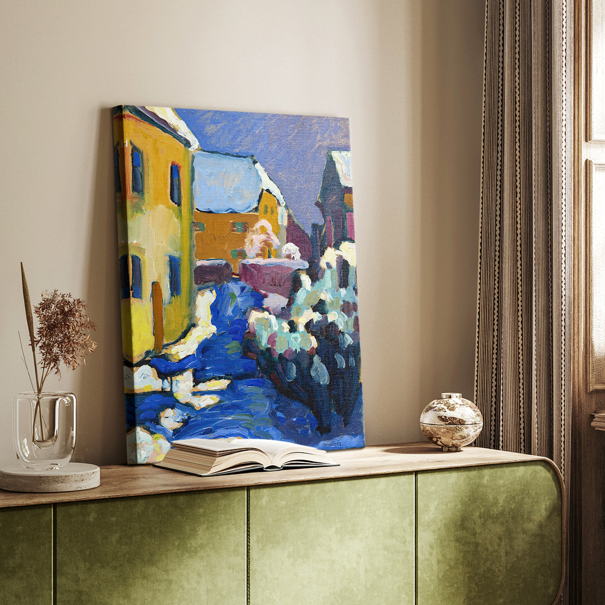 Canvas art print of a stylized village scene with simplified forms and vivid tones styled in a home decor setting.