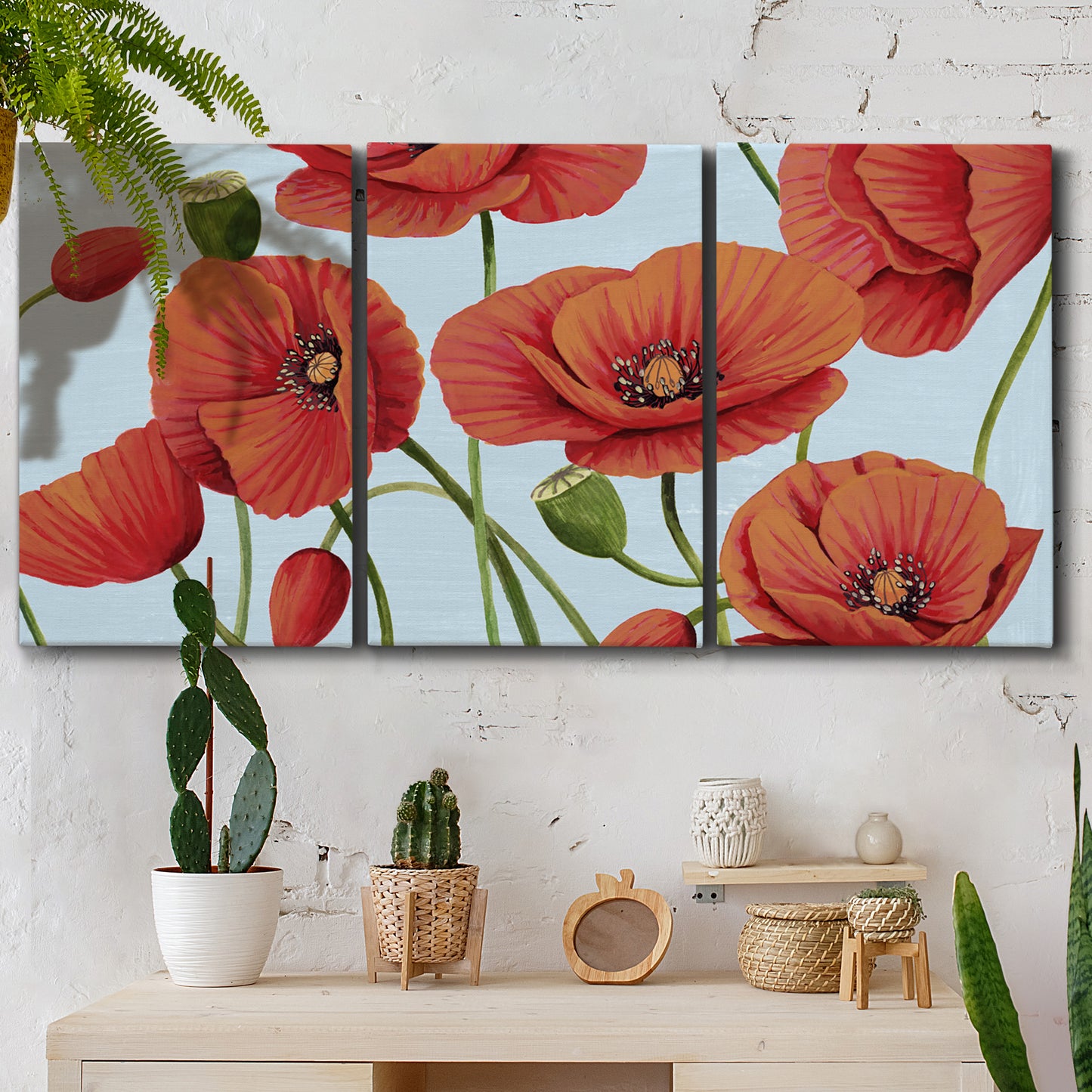 Three-panel canvas wall art featuring red poppies in motion, displayed in a boho-chic entryway above a console table.
