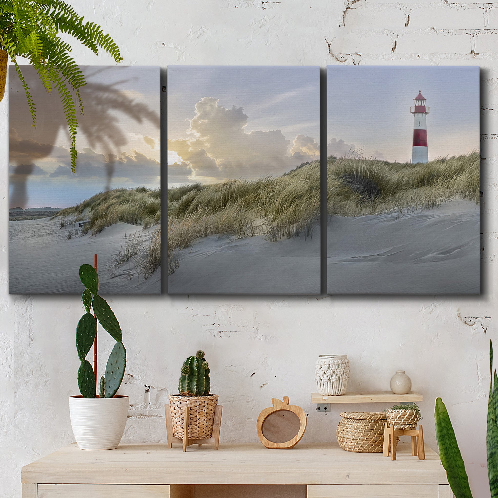 Three-panel canvas wall art featuring guardian boat along shoreline, displayed in a boho-chic entryway above a console table.