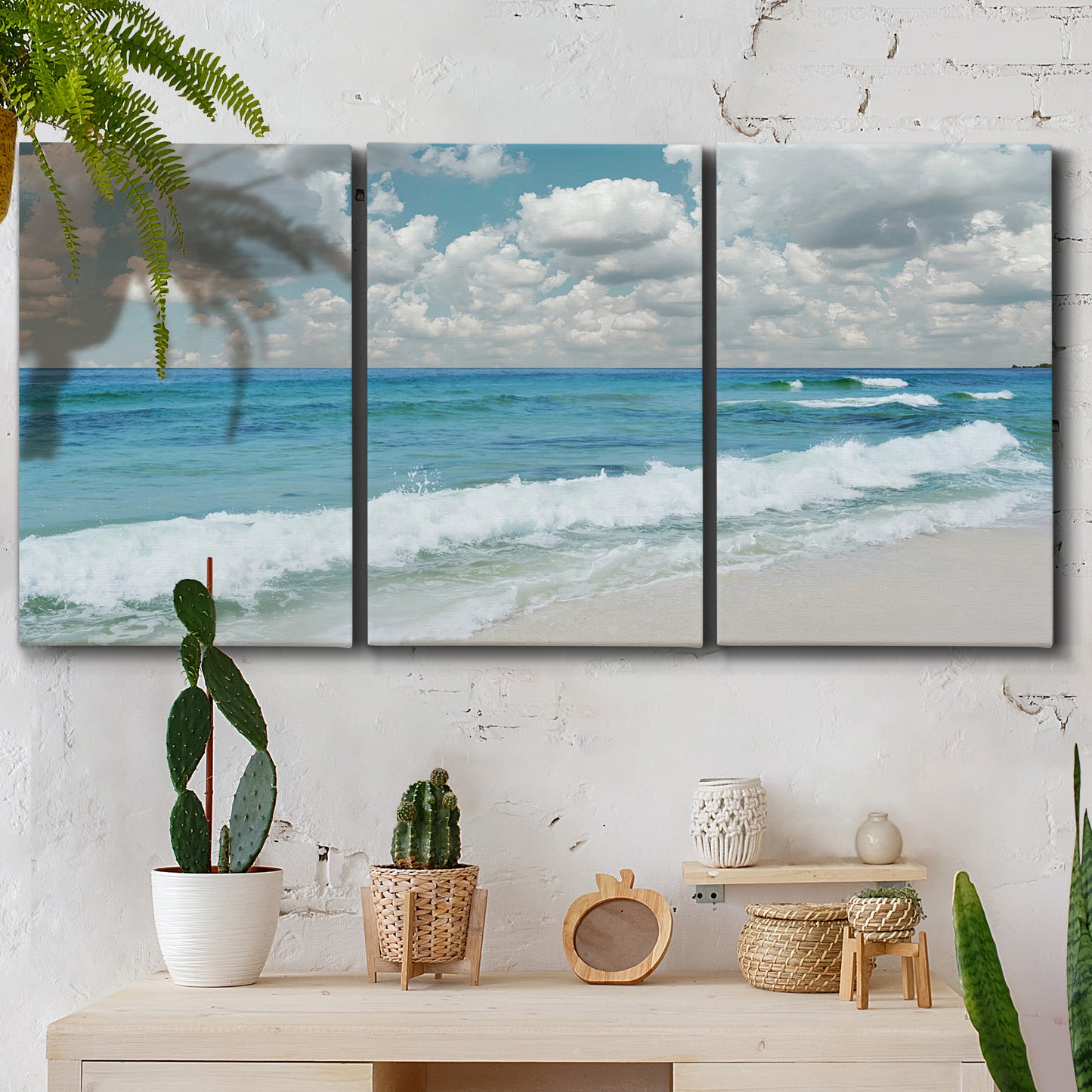 Three-panel canvas wall art featuring tropical beach scene with turquoise water, displayed in a boho-chic entryway above a console table.