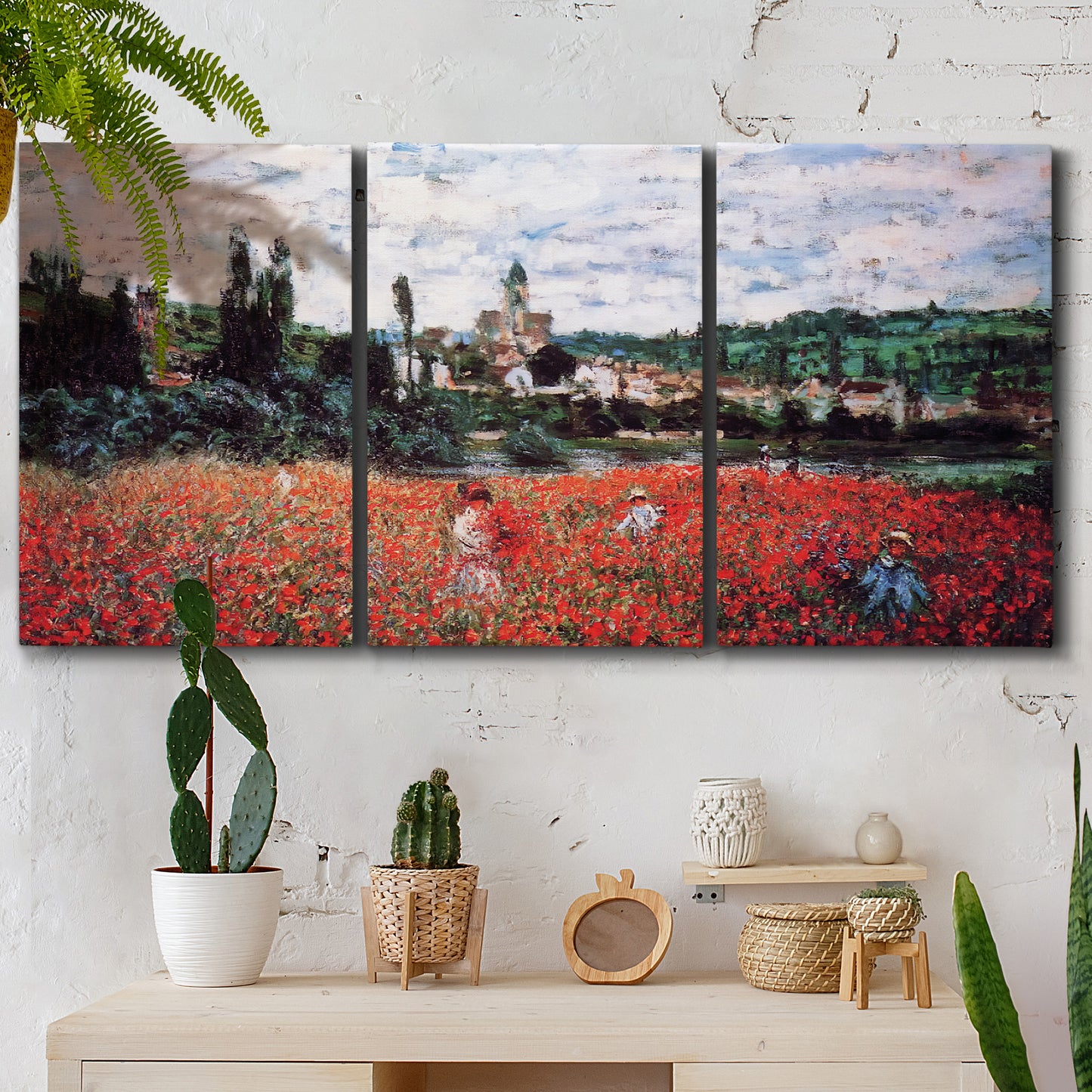 Three-panel canvas wall art featuring poppy field beside village landscape, displayed in a boho-chic entryway above a console table.