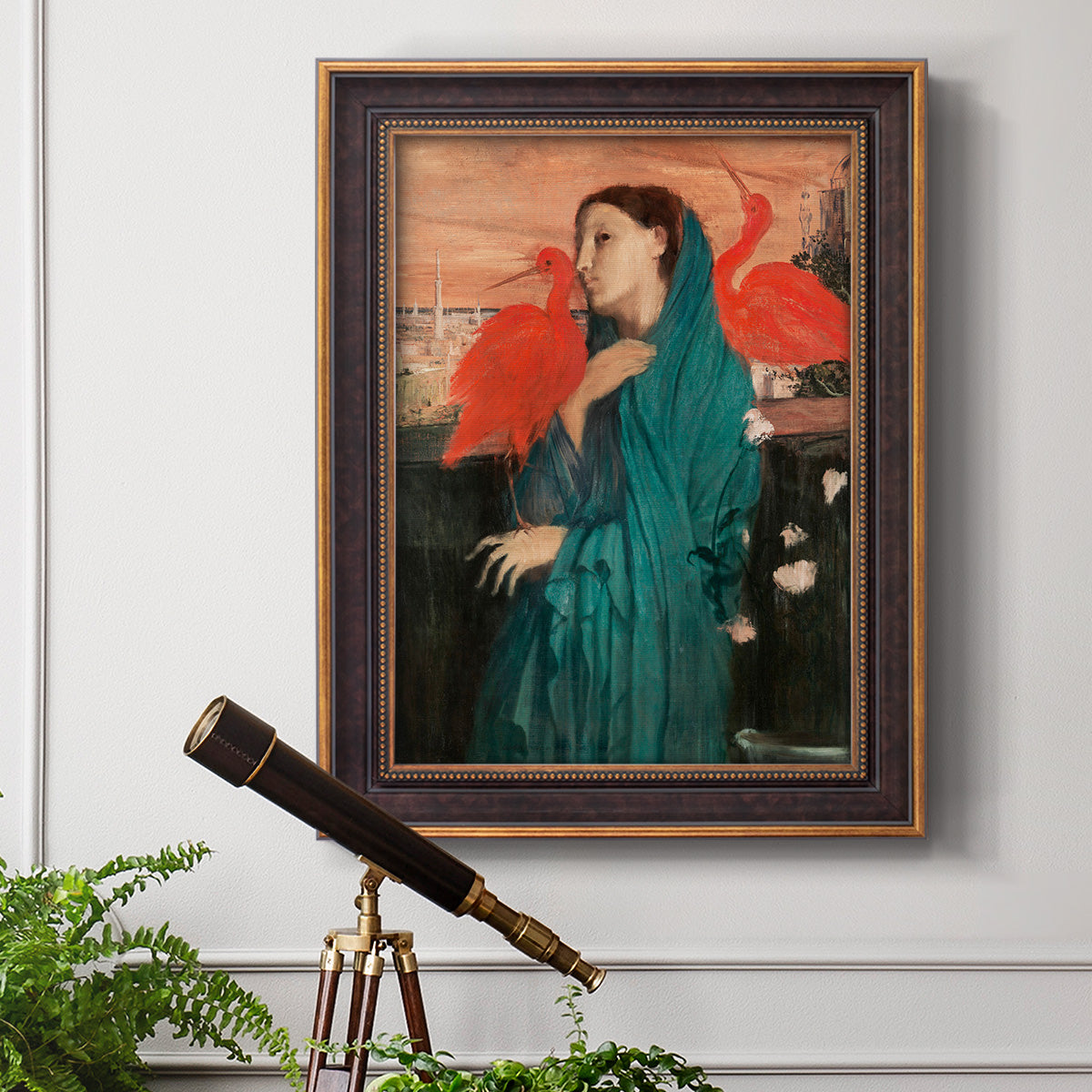 Impressionist portrait of a young woman with an ibis by Edgar Degas in an ornate bronzed mahogany wood frame displayed in a light-toned interior setting.