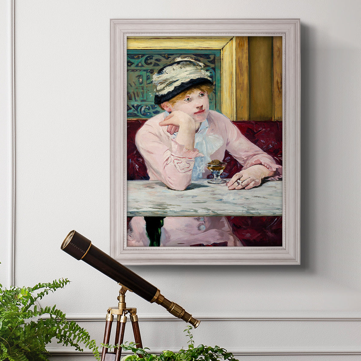 Impressionist portrait scene with plum brandy by Édouard Manet in an ornate weathered white frame displayed in a light-toned interior setting.