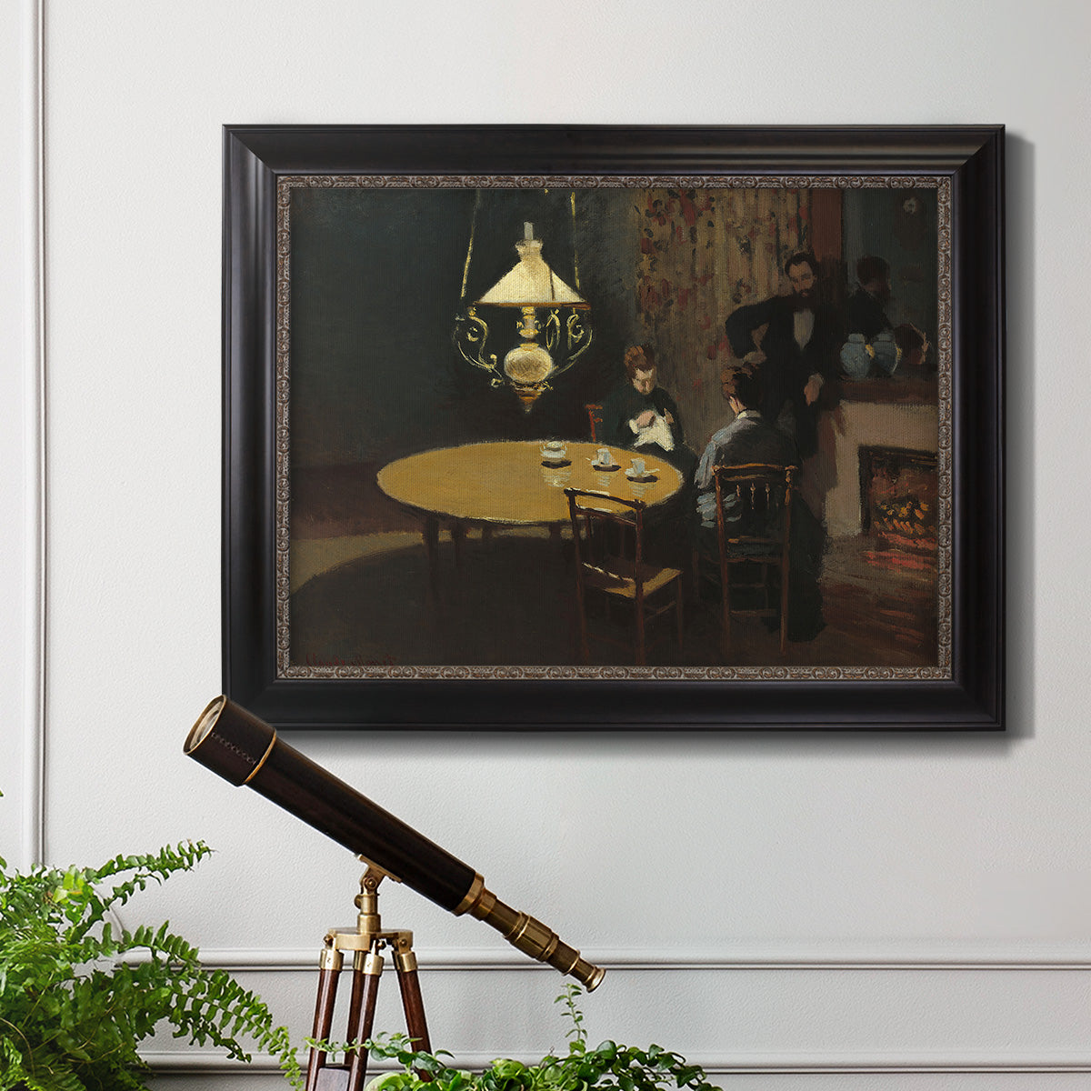 Impressionist domestic interior scene by Claude Monet in an ornate black frame with gilded inner detail displayed in a light-toned interior setting.