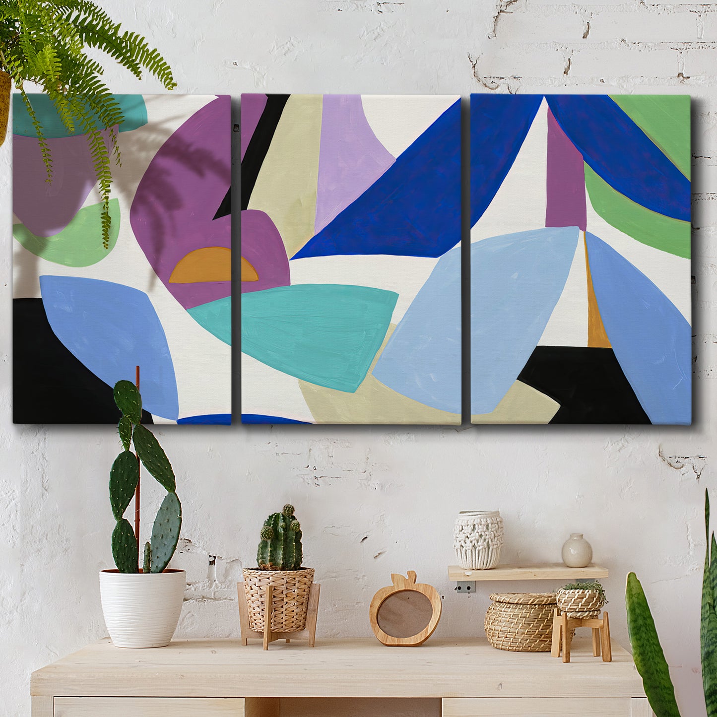 Three-panel canvas wall art featuring colorful abstract homage to modernism, displayed in a boho-chic entryway above a console table.