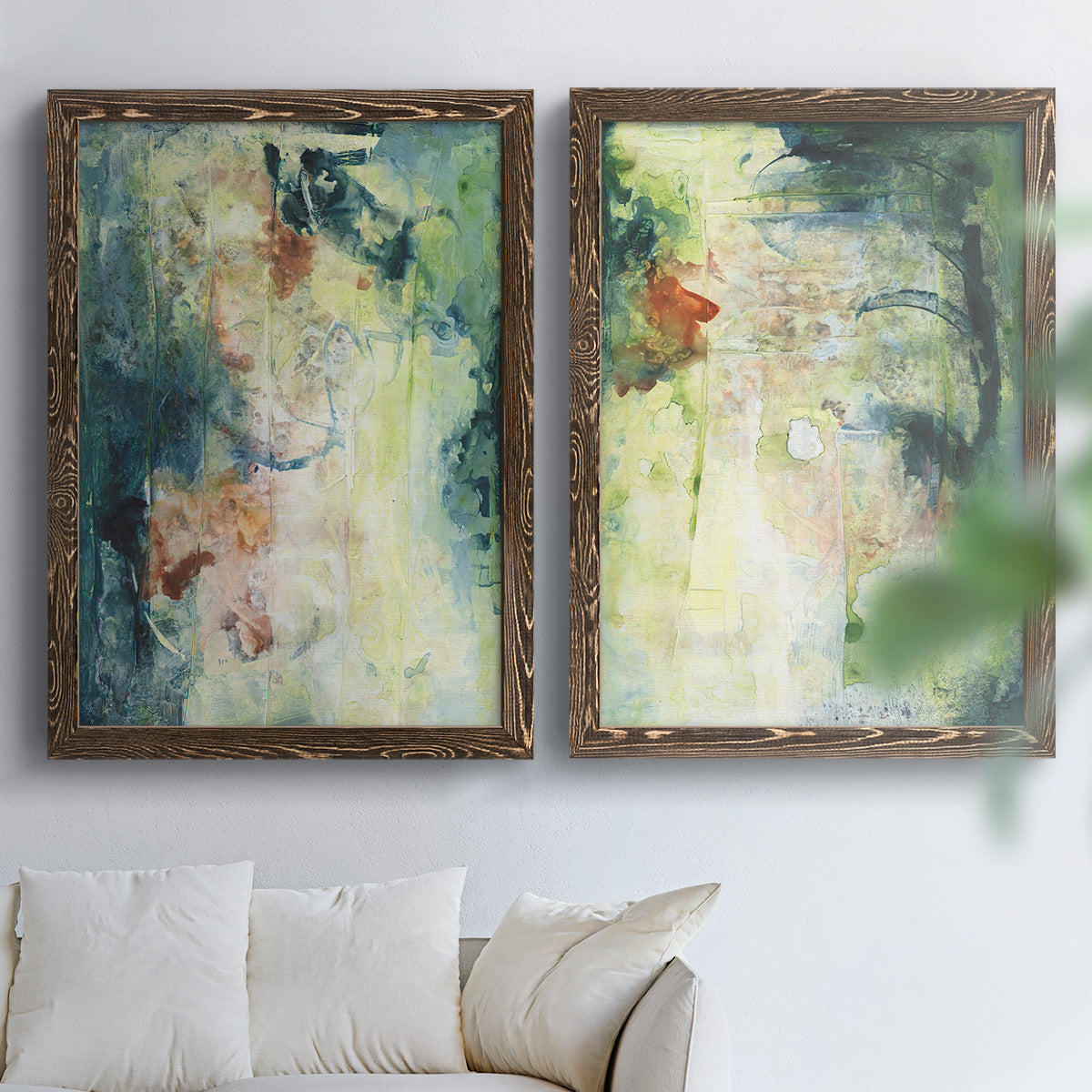 Set of two walnut barnwood framed canvas prints depicting vertical organic marks, pale light passages, and weathered surfaces arranged across two complementary compositions above a sofa in a bright living space.