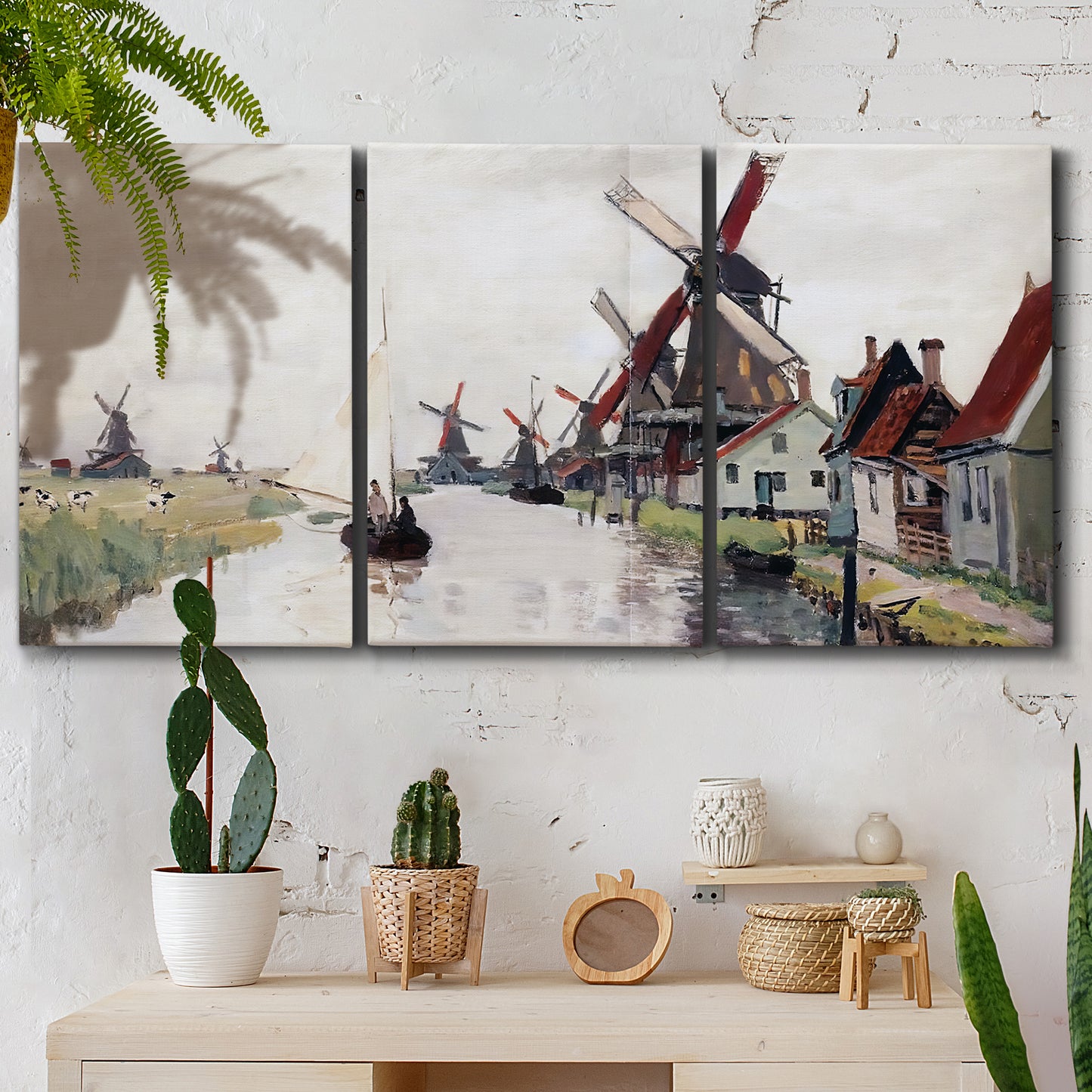 Three-panel canvas wall art featuring windmills beside calm water, displayed in a boho-chic entryway above a console table.