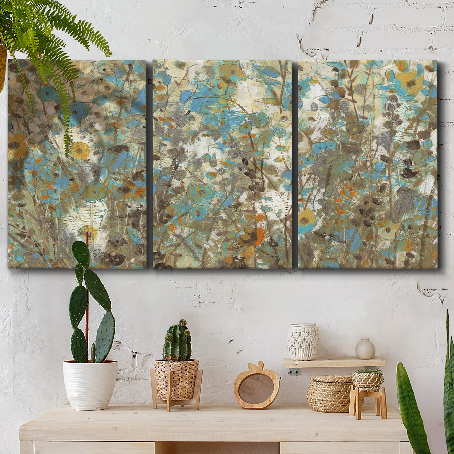 Three-panel canvas wall art featuring abstract flowering vine pattern, displayed in a boho-chic entryway above a console table.