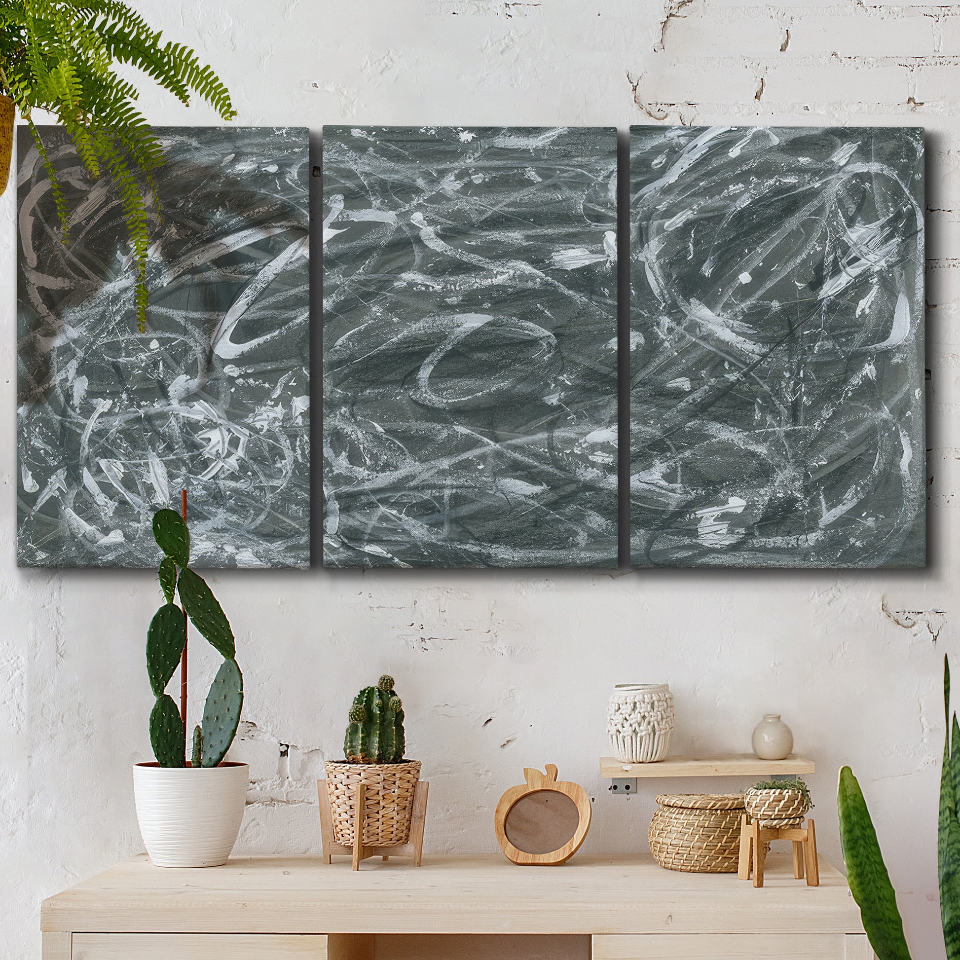 Three-panel canvas wall art featuring abstract view through window forms, displayed in a boho-chic entryway above a console table.