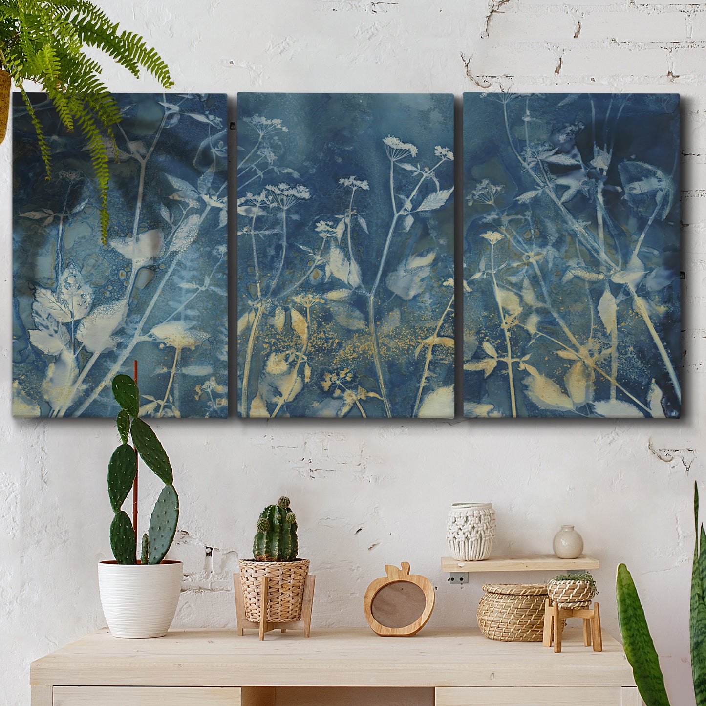 Three-panel canvas wall art featuring dark abstract with rich tonal depth, displayed in a boho-chic entryway above a console table.