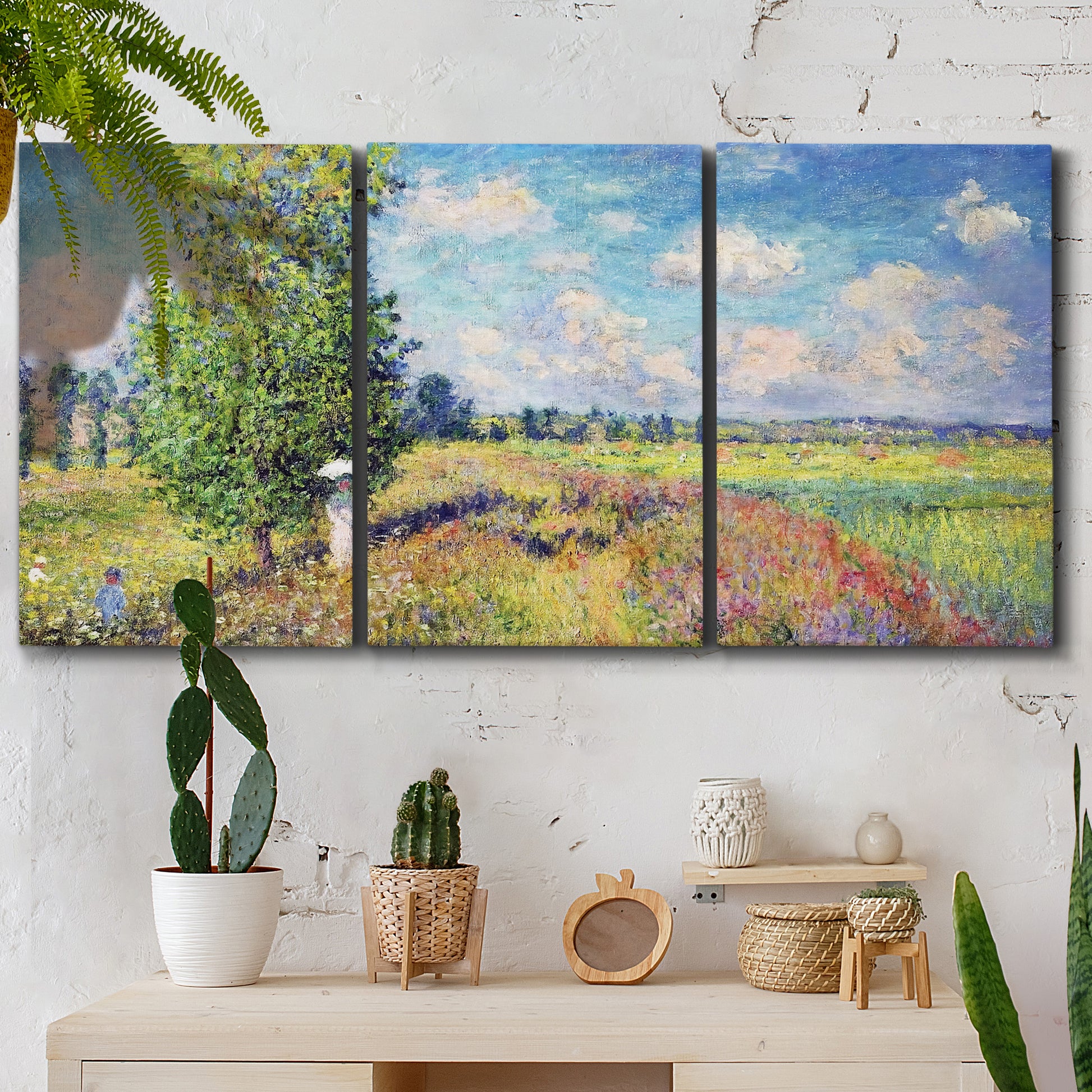 Three-panel canvas wall art featuring sunlit meadow landscape, displayed in a boho-chic entryway above a console table.