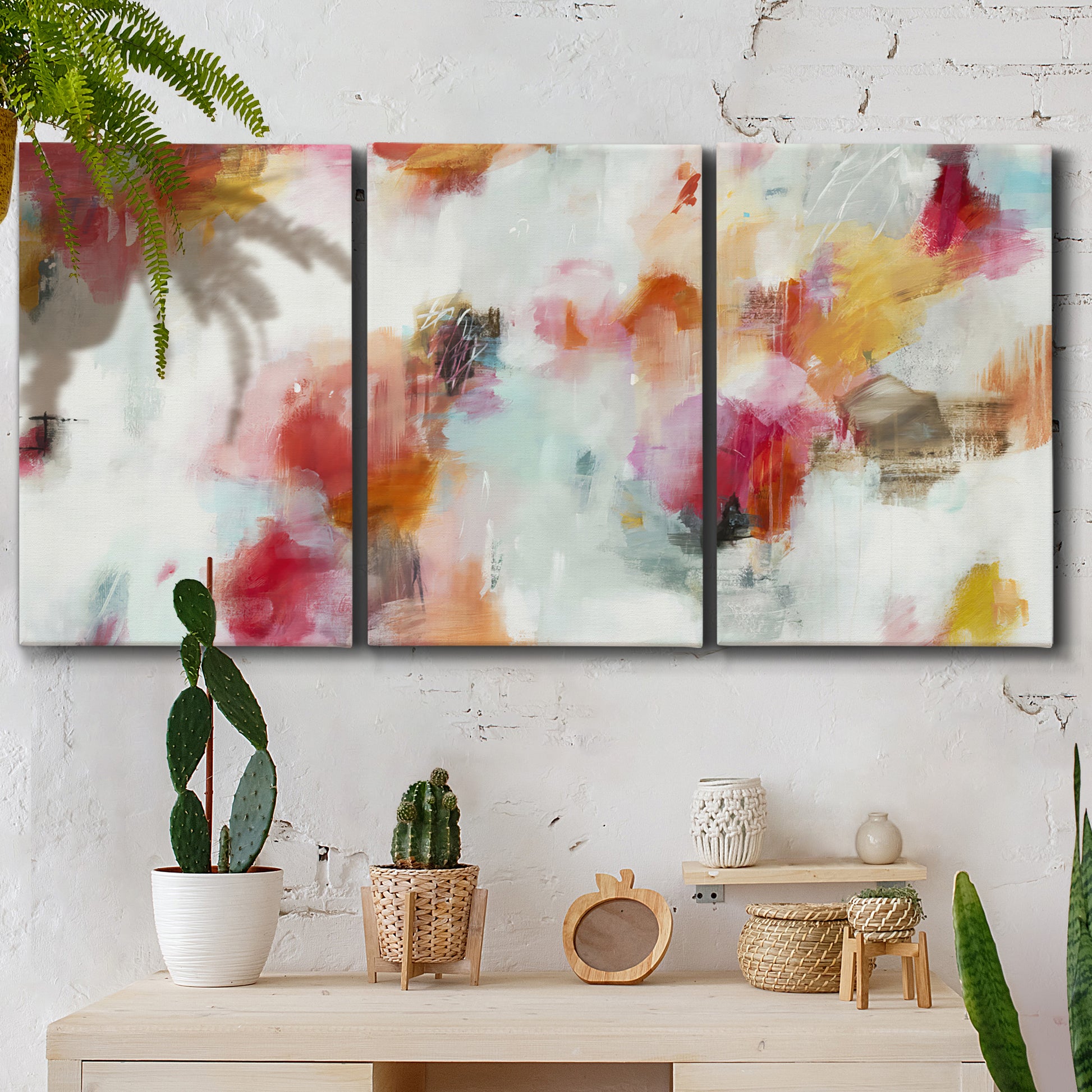 Three-panel canvas wall art featuring abstract directional visual shift, displayed in a boho-chic entryway above a console table.