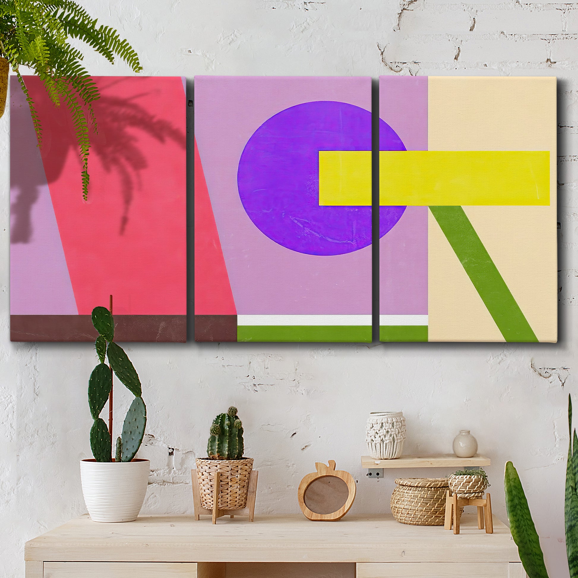 Three-panel canvas wall art featuring bold geometric color abstraction, displayed in a boho-chic entryway above a console table.