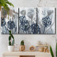 Three-panel canvas wall art featuring indigo floral abstraction, displayed in a boho-chic entryway above a console table.