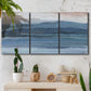 Three-panel canvas wall art featuring wide lake with distant shoreline, displayed in a boho-chic entryway above a console table.