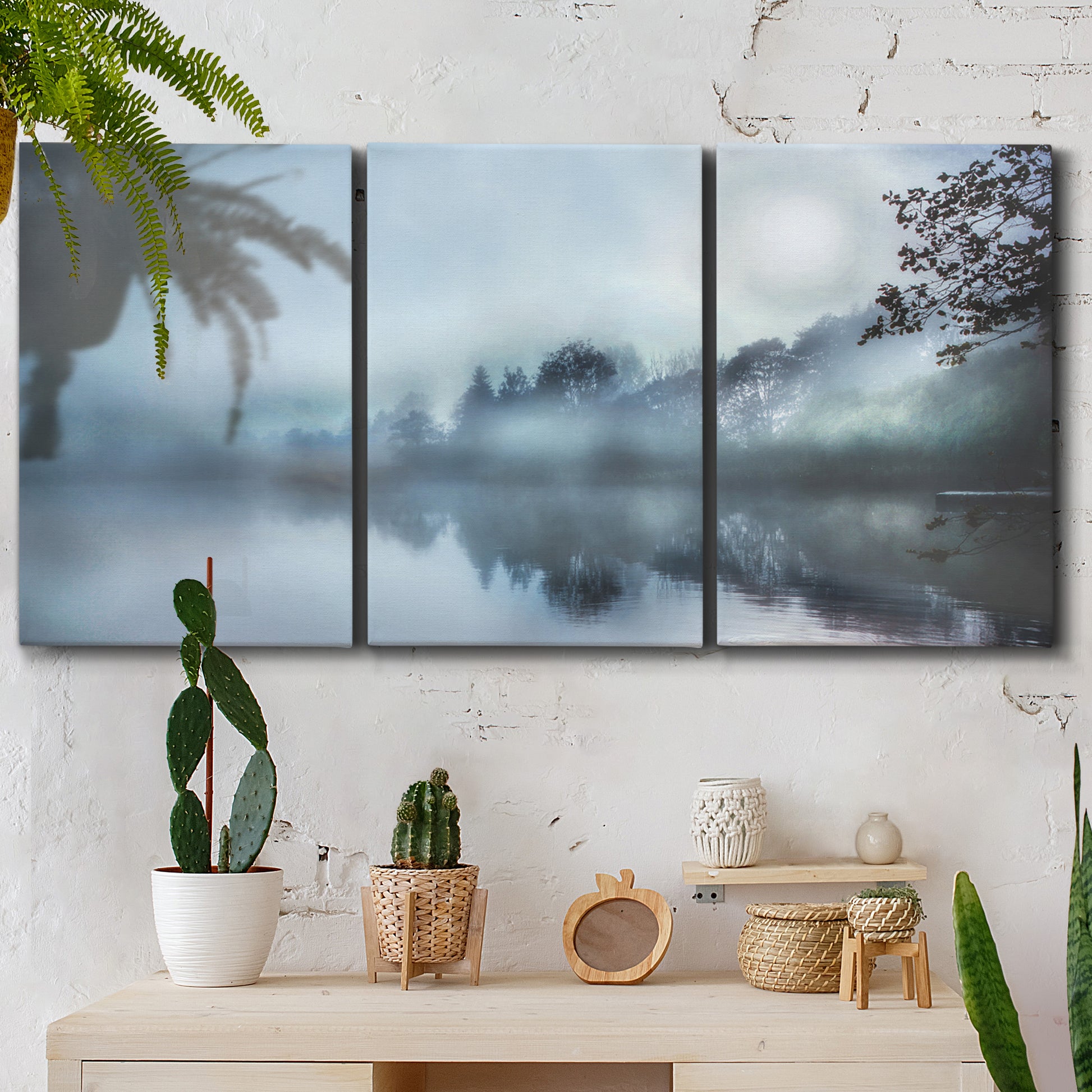 Three-panel canvas wall art featuring calm waters at sunrise photograph, displayed in a boho-chic entryway above a console table.