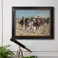 Impressionist western action scene by Frederic Remington in an ornate black frame with gilded inner detail displayed in a light-toned interior setting.