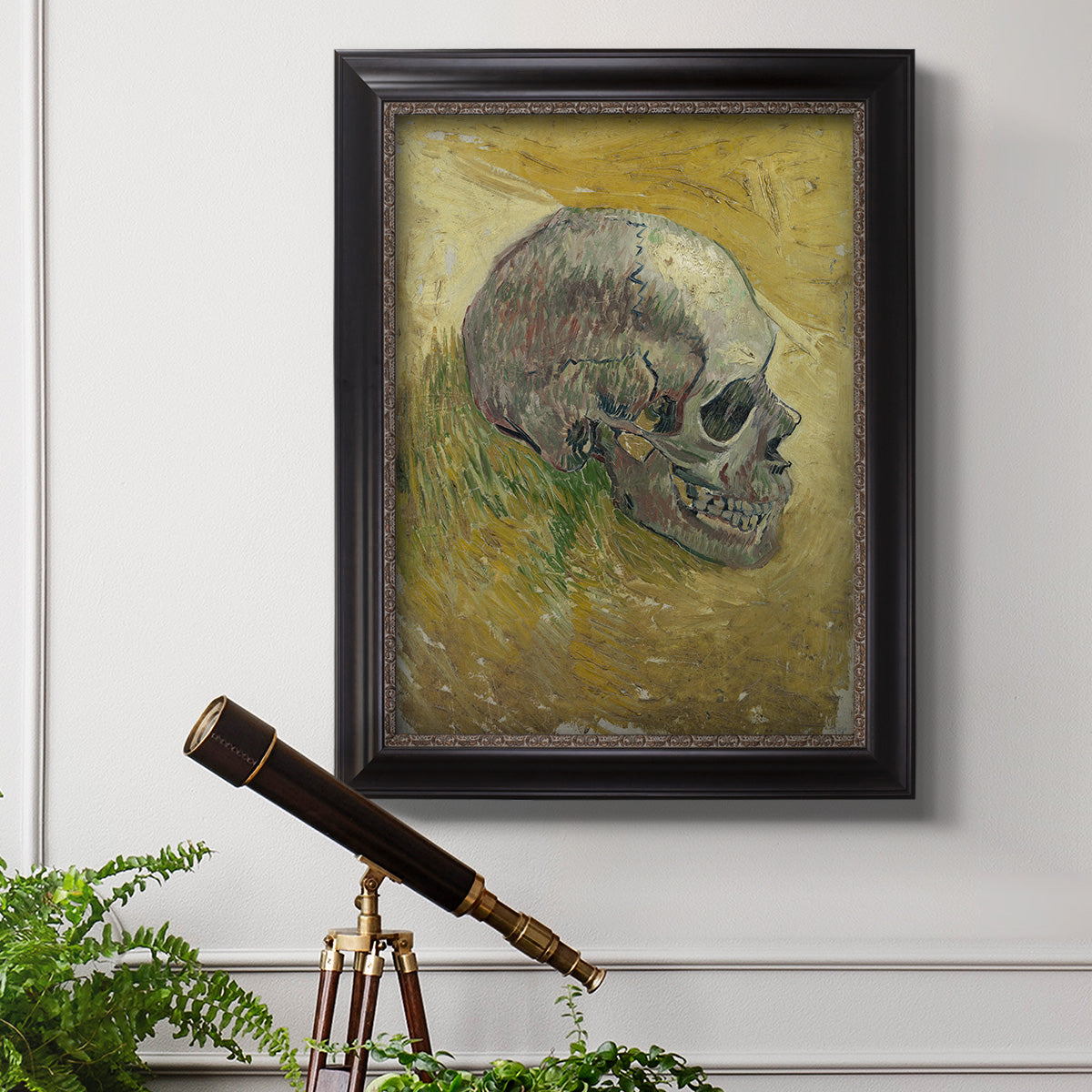 Profile skull study artwork by Vincent van Gogh in an ornate black frame with gilded inner detail displayed in a light-toned interior setting.