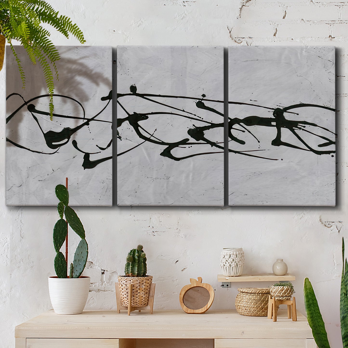 Three-panel canvas wall art featuring minimal abstract frequency lines, displayed in a boho-chic entryway above a console table.