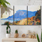 Three-panel canvas wall art featuring winding red road hillside, displayed in a boho-chic entryway above a console table.