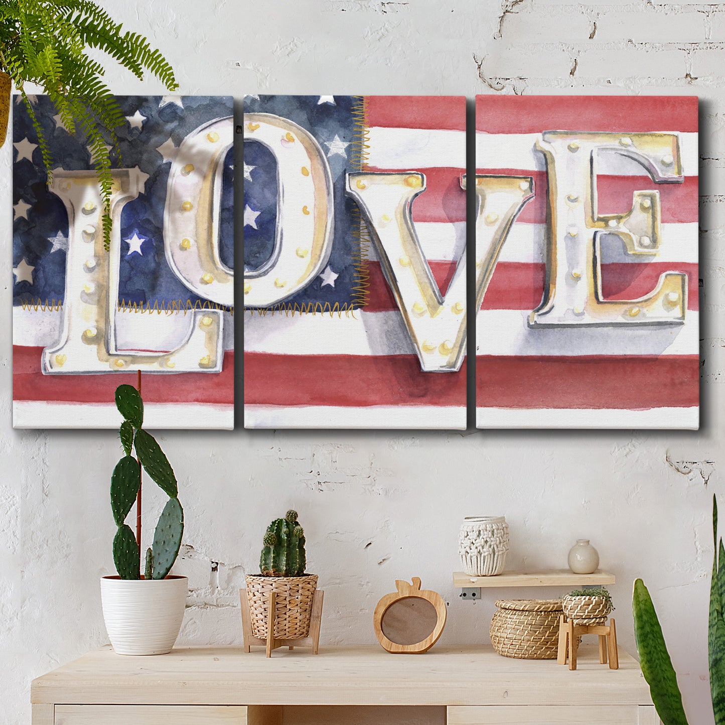 Three-panel canvas wall art featuring patriotic rustic typography art, displayed in a boho-chic entryway above a console table.
