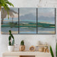 Three-panel canvas wall art featuring twilight landscape with fading light, displayed in a boho-chic entryway above a console table.