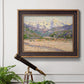 Impressionist valley landscape in southern France by Claude Monet in an ornate bronzed mahogany wood frame displayed in a light-toned interior setting.