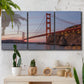 Three-panel canvas wall art featuring golden gate bridge spanning bay, displayed in a boho-chic entryway above a console table.