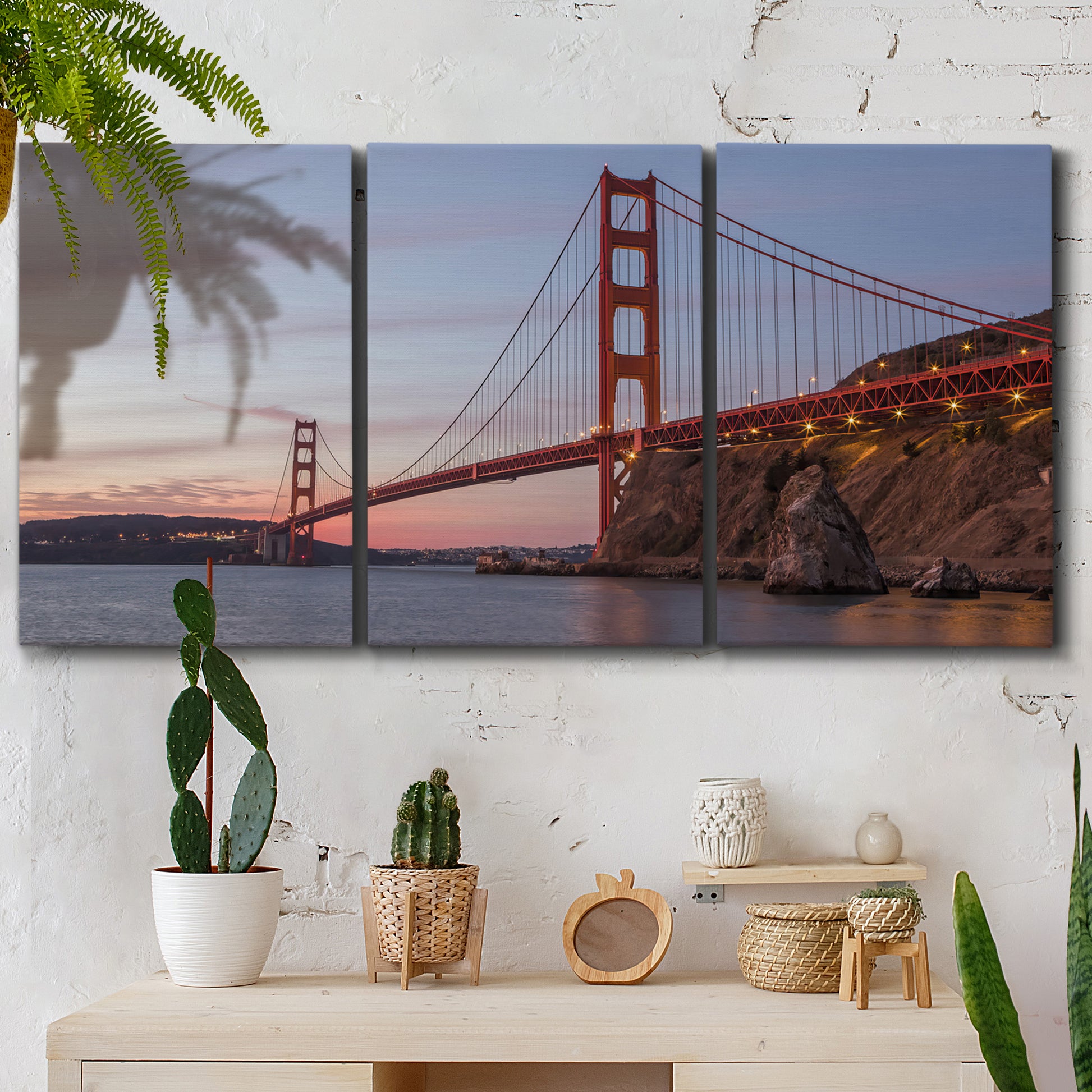 Three-panel canvas wall art featuring golden gate bridge spanning bay, displayed in a boho-chic entryway above a console table.