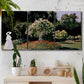 Three-panel canvas wall art featuring woman seated in garden landscape, displayed in a boho-chic entryway above a console table.