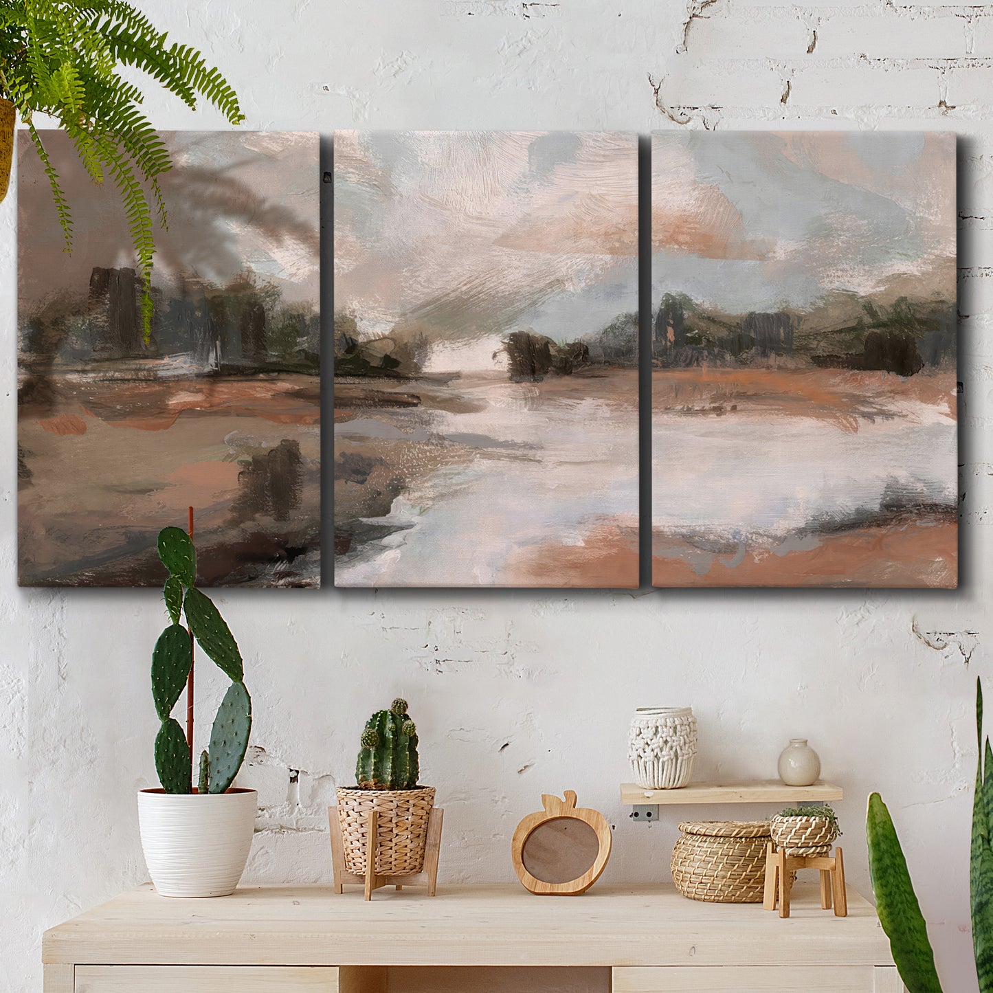 Three-panel canvas wall art featuring quiet pond with soft reflections, displayed in a boho-chic entryway above a console table.