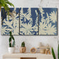 Three-panel canvas wall art featuring delicate lupine floral composition, displayed in a boho-chic entryway above a console table.